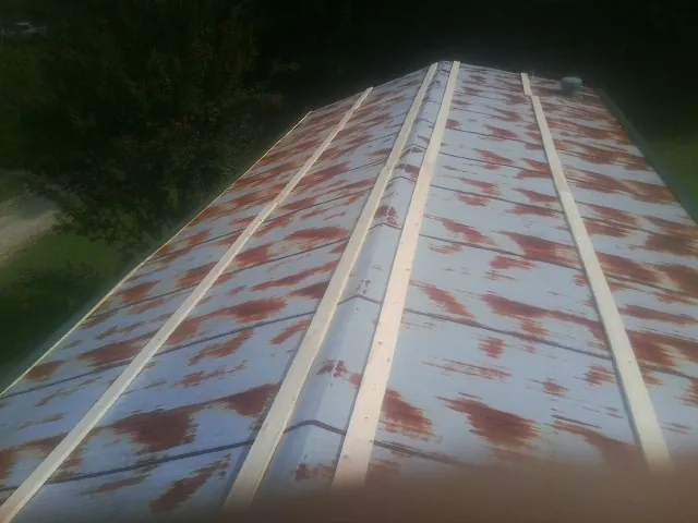 Rusted metal roof panels with new wood purlins before replacement — Storm Damage Roof Repair in Rockledge by Roofing Brothers