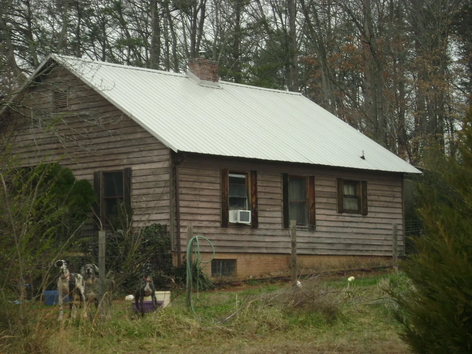 White metal roof on an old wood sided farmhouse, from a Metal Roof Installation job in Rockledge